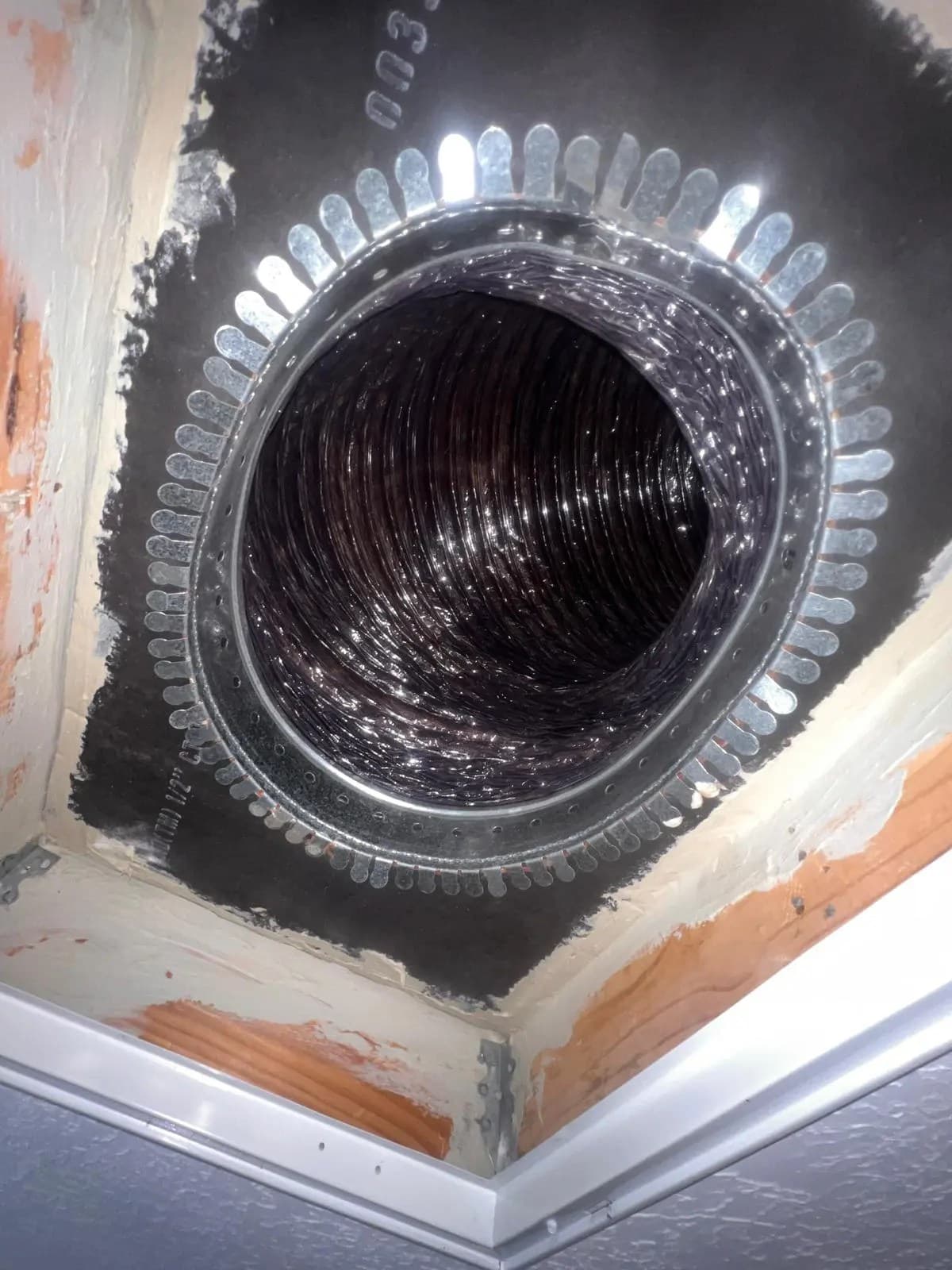 Close view inside an installed residential flexible air duct connection